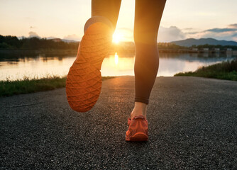 Woman running outdoors. Healthy lifestyle concept, people go in sports. Silhouette family at sunset. Health care, authenticity, sense of balance and calmness.

