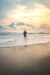 Naklejka premium A Lonely Young Man on Solo Vacation at The Samas Beach in Bantul Regency