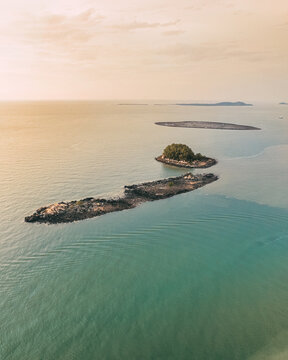 Remote island with turquoise water  in Karimun Regency. Asam island from birds eye.
