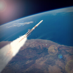 Rocket above the earth. The elements of this image furnished by NASA.