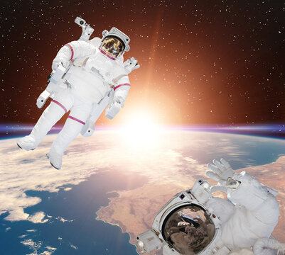 Astronauts flies in space. The elements of this image furnished by NASA.