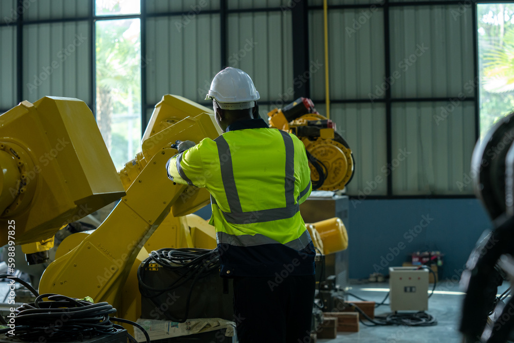Aufkleber Engineer working with robot arm automated welding machine in modern metal factory.