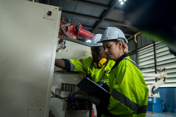 Engineer inspect robotic arm in workshop,Checking quality of workpieces manufacturing industry technology.