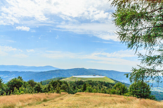 View from Kiczera on a sunny summer day at the artificial reservoir of the pumped-storage power plant on the Żar mountain in the Silesian Beskids, Poland.