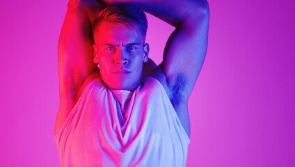 I never neglect the warmup. Studio portrait of a handsome young man stretching against a purple background.