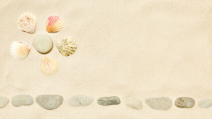 Fototapeta na wymiar Beach sand with Sun symbol of seashells and pebbles