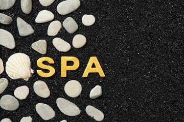 Spa word in black sand with pebbles