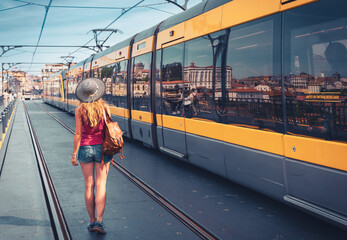 Woman waiting tramway- Porto city in Portugal- travel, tourism, vacation concept