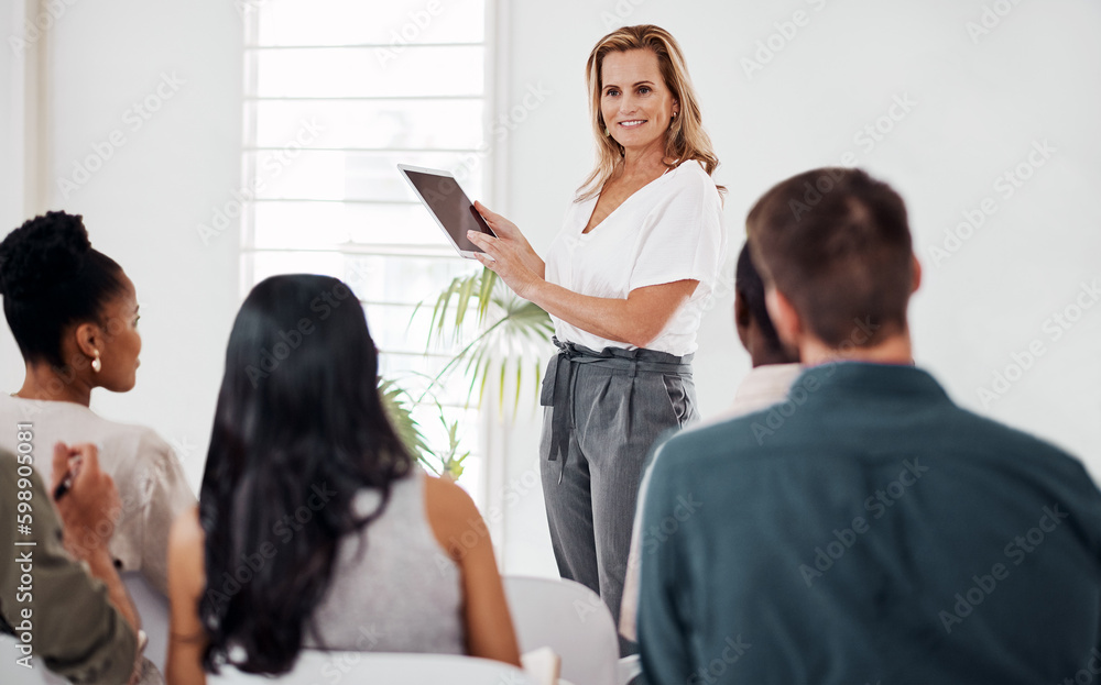 Aufkleber and thats as simple as it gets. a mature businesswoman using a digital tablet while speaking at a co