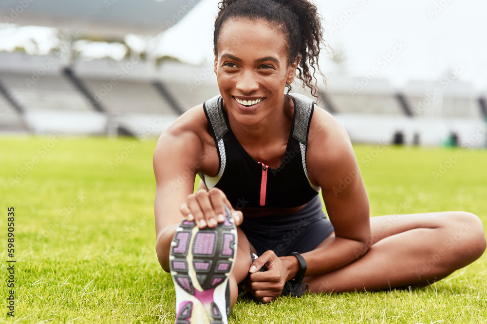 Poster Never exercise without first warming up. an attractive young female athlete warming up at the track.