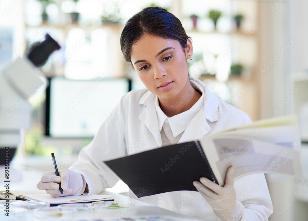 Aufkleber Jotting down some new data. a young scientist writing notes while working in a lab.