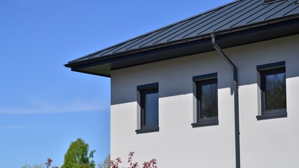 Terraced family homes in newly developed housing estate. The real estate market in the suburbs. New single family houses in a new development area. Residential homes with modern facade. 