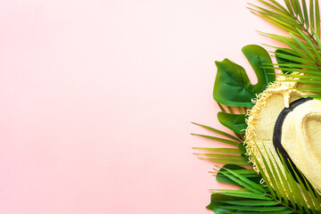 Summer composition flat lay. Palm leaves, sea shells, hat and sunglasses on pink background.