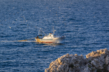 Fish boat seen from Zafferano Cape on Tyrrhenian coast near Santa Flavia city on Sicily Island, Italy