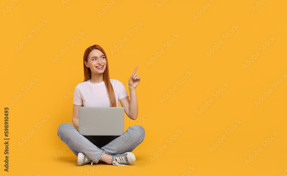 Poster Smiling young woman with laptop on yellow background, space for text