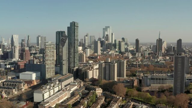 Descending aerial shot of London skyscrapers and city road
