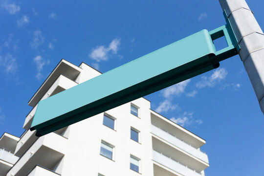 Street name pole. Signpost isolated on nlue sky. Empty copy space. Blank information place. Tourist guide arrow. Modern neighbourhood. Brand new block of flats. Sunny city balcony.