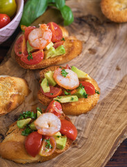 Homemade bruschetta with shrimps, avocado and cherry tomato - 598916840
