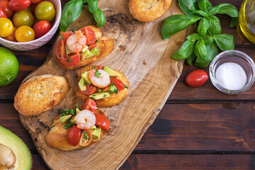 Homemade bruschetta with shrimps, avocado and cherry tomato - 598916841