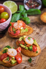 Homemade bruschetta with shrimps, avocado and cherry tomato - 598916877