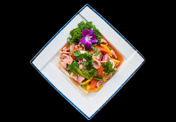 Vietnamese calamari with stewed vegetables and pineapple isolated on black background