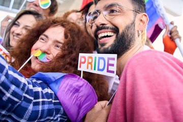 Close up diverse group of happy young people taking funny selfie for social media celebrating gay...