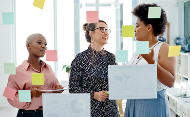 Making plans as they take action towards their goals. a group of businesswomen brainstorming with...