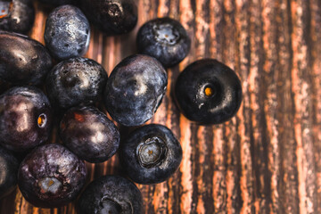 Scattered Blueberries on Rustic Wooden Background