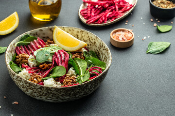 Healthy salad with baby spinach, nuts and cheese. Restaurant menu, dieting, cookbook recipe top view