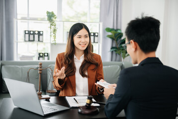 justice and law concept.passing bribe money in the envelop at office. businessman hand taking bribe money from female..