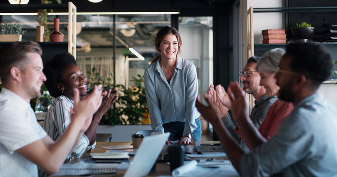 Growth is a result of everyone working together. a group of businesspeople clapping during a meeting in a modern office.