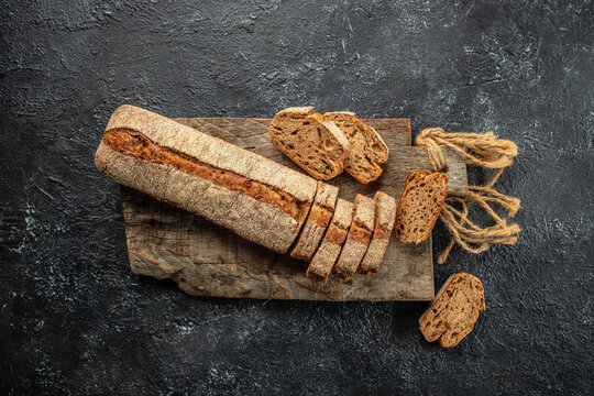 baguette bread or bread roll on a wooden board. banner, menu, recipe place for text, top view
