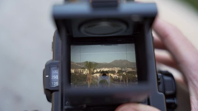 Close up of taking photo of Spanish landscape on medium format film photo camera