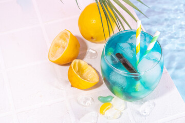 Funny Fish bowl mocktail. Cold blue colored sour lemon Fishbowl Cocktail with rum, liqueur, citrus...