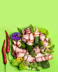 Pork delicacies with salad and herbs on a plate.