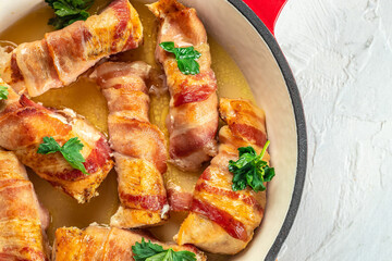 Bacon wrapped chicken drumsticks in pan. Healthy fats, clean eating for weight loss. place for text, top view