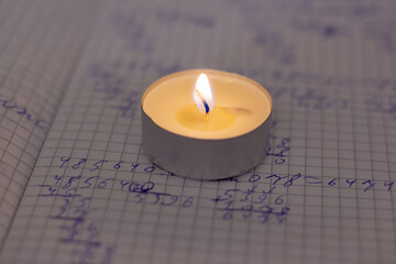 Power outage. Home school assignments are about candles. Elementary school math problems and a...