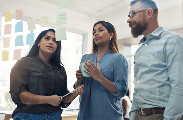 We really need to plan this through. a diverse group of businesspeople standing together and using...