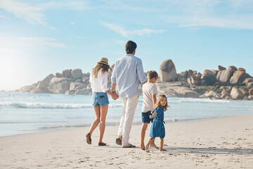 My family will always protect me. Rearview shot of an unrecognizable couple holding hands with their two young children and walking along the beach.