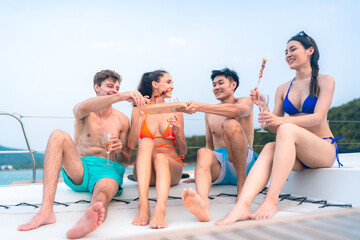 happy man in swimwear and woman in bikini having laugh fun in summer trip with friends group by eat...