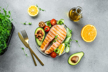Grilled salmon steak with avocado and fresh vegetable salad. Keto diet, Healthy food concept. place for text, top view