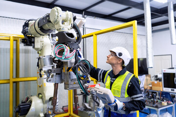 Engineer service robot welding in factory software programming operation test and commissioning