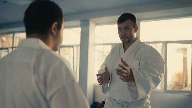 Taekwondo master teaching how to block punches or kicks in martial art school