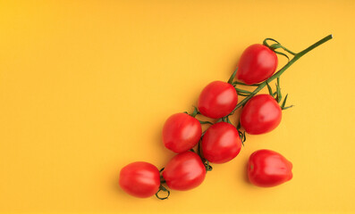 red cherry tomatoes on yellow background