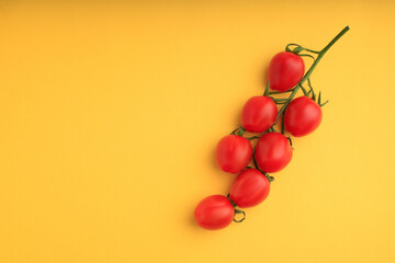 red cherry tomatoes on yellow background