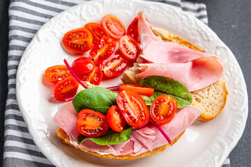 bruschetta ham sandwich tomato, lettuce snack meal food snack on the table copy space food background rustic top view