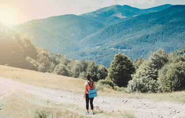 A sports tourist walks along a mountain range. The concept of a healthy lifestyle. Happy and healthy weekend