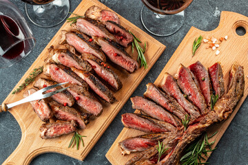 Sliced grilled beef barbecue Striploin steak on a wooden board, Restaurant menu, dieting, cookbook recipe top view
