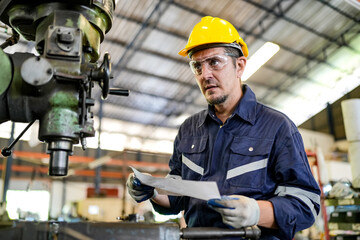 Lathe Operators Concentrated on Work. Worker in uniform and helmet works on lathe, factory. Industrial production, metalwork engineering, manufacturing.