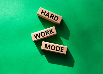 Hard Work Mode symbol. Concept word Hard Work Mode on wooden blocks. Beautiful green background. Business and Hard Work Mode concept. Copy space